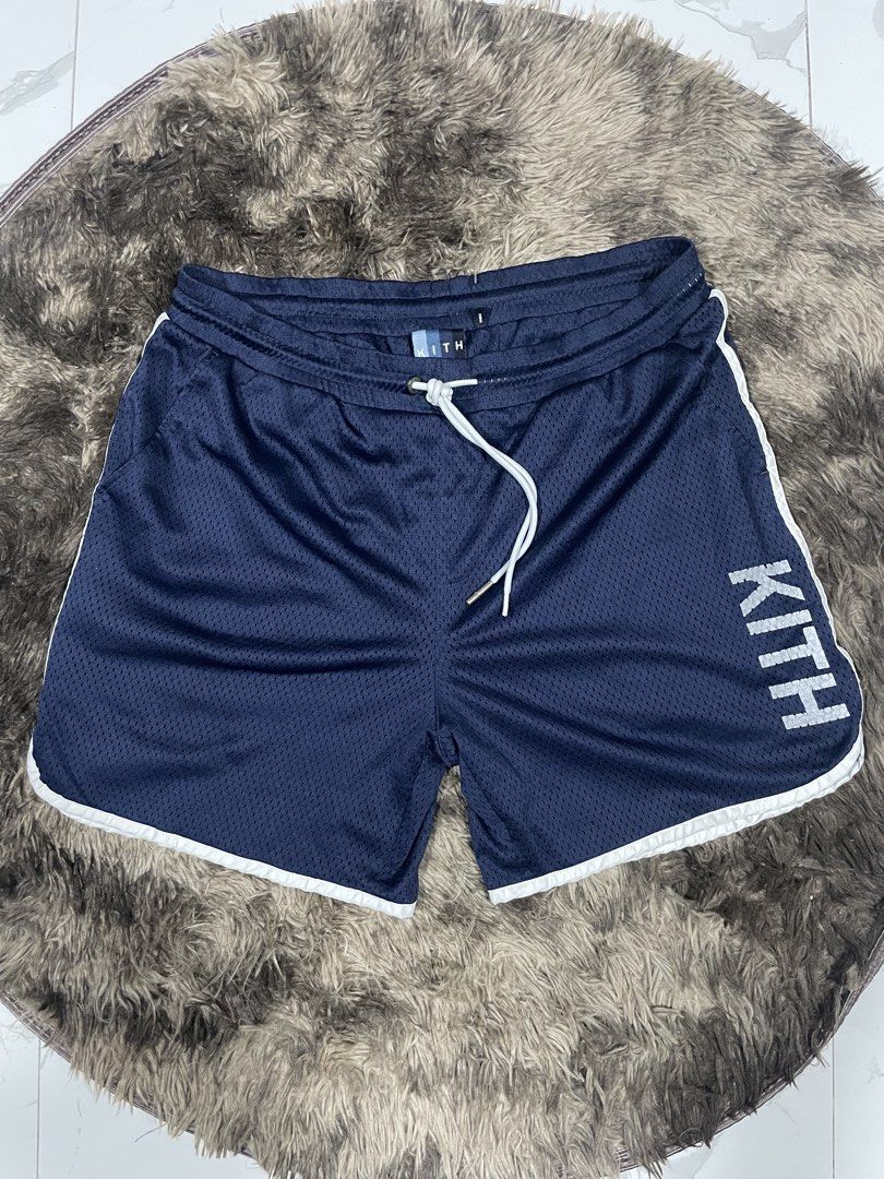 Kith Navy Blue Mesh Shorts Size M (Category: Shorts) located in Calapan. Submitted by lucasthrifts (Listing ID 1465922650, Image 1). Description: - Brand: Kith - Item: Mesh Shorts - Color: Navy Blue with white contrast piping - Size: Medium (Tag attached) - Condition: Presentable - Features: Breathable mesh fabric, white waist drawstrings, large Kith logo on left leg, and a back zippered pocket with branded hardware -30-36 waist.