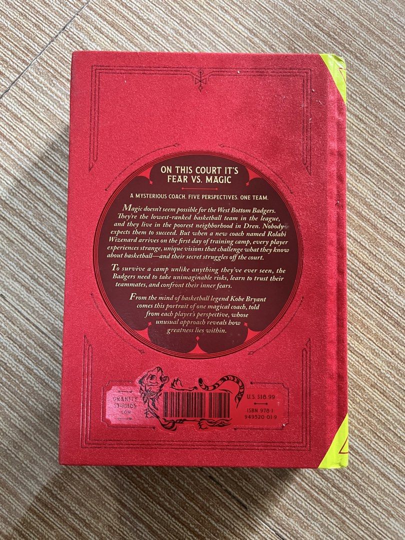 Kobe Bryant Wizenard (Category: Storybooks) located in Pasay City. Submitted by thejunkclosetph (Listing ID 1465773156, Image 3). Description: - Title: The Wizenard Series: Training Camp - Created by: Basketball legend Kobe Bryant - Written by: Wesley King - Format: Hardcover book with striking red cover and gold abstract detailing - Perfect for: Kobe fans, basketball enthusiasts, collectors, and young readers.