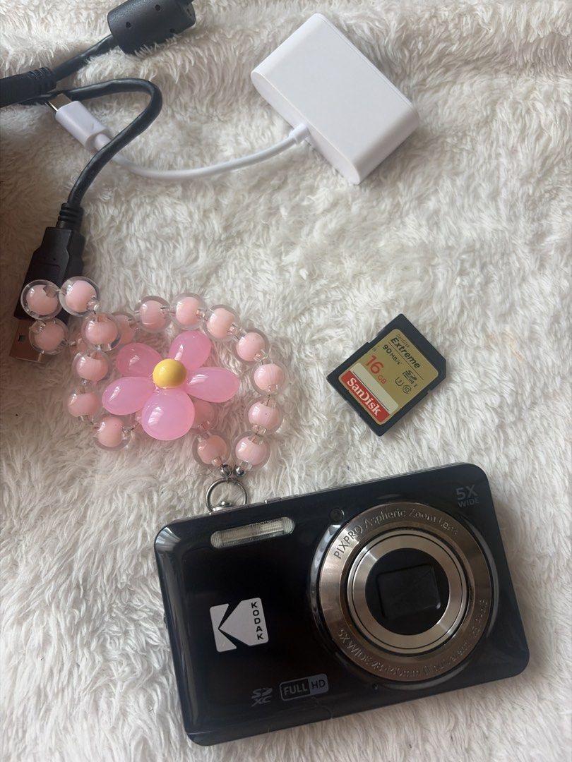 Kodak Pixpro FZ55 Digital Camera (Category: Cameras) located in Quezon City. Submitted by maggiemajiing (Listing ID 1465808417, Image 3). Description: - Model: Kodak Pixpro FZ55 Digital Camera (Black) - Condition: Fully tested, powers on, shoots photos, and ready to use - Included: Original box, charging block, and memory Card reader - Extras: Cute pink beaded wrist strap, pink carrying case, and SanDisk 16GB Extreme SD card - Perfect for: Beginn