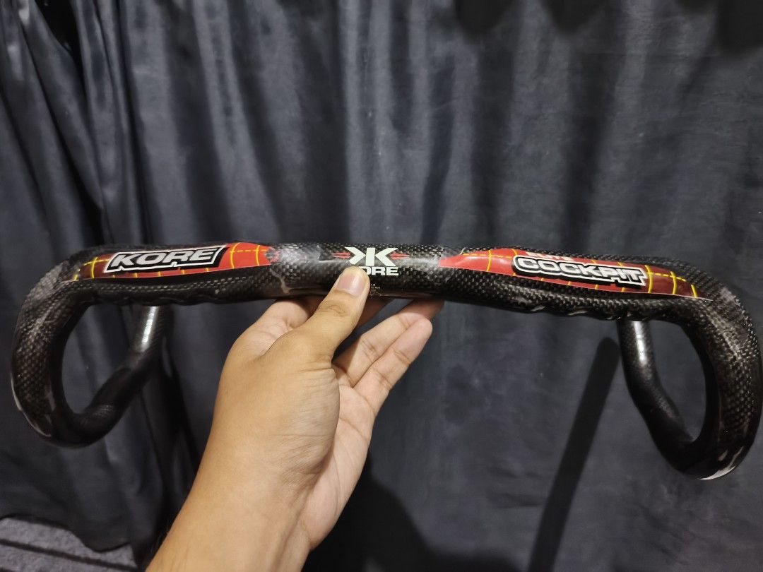 Kore Elite Cockpit Carbon Bicycle Handlebar (Category: Bicycles) located in Manila. Submitted by silverowl_a4061a (Listing ID 1465870519, Image 1). Description: - Brand/Model: Kore Elite Carbon Drop Bar - Material: Lightweight carbon construction - Design: Distinct red and white graphics on top - Fit: Standard center clamp area - Condition: Ready to mount, great road bike upgrade.