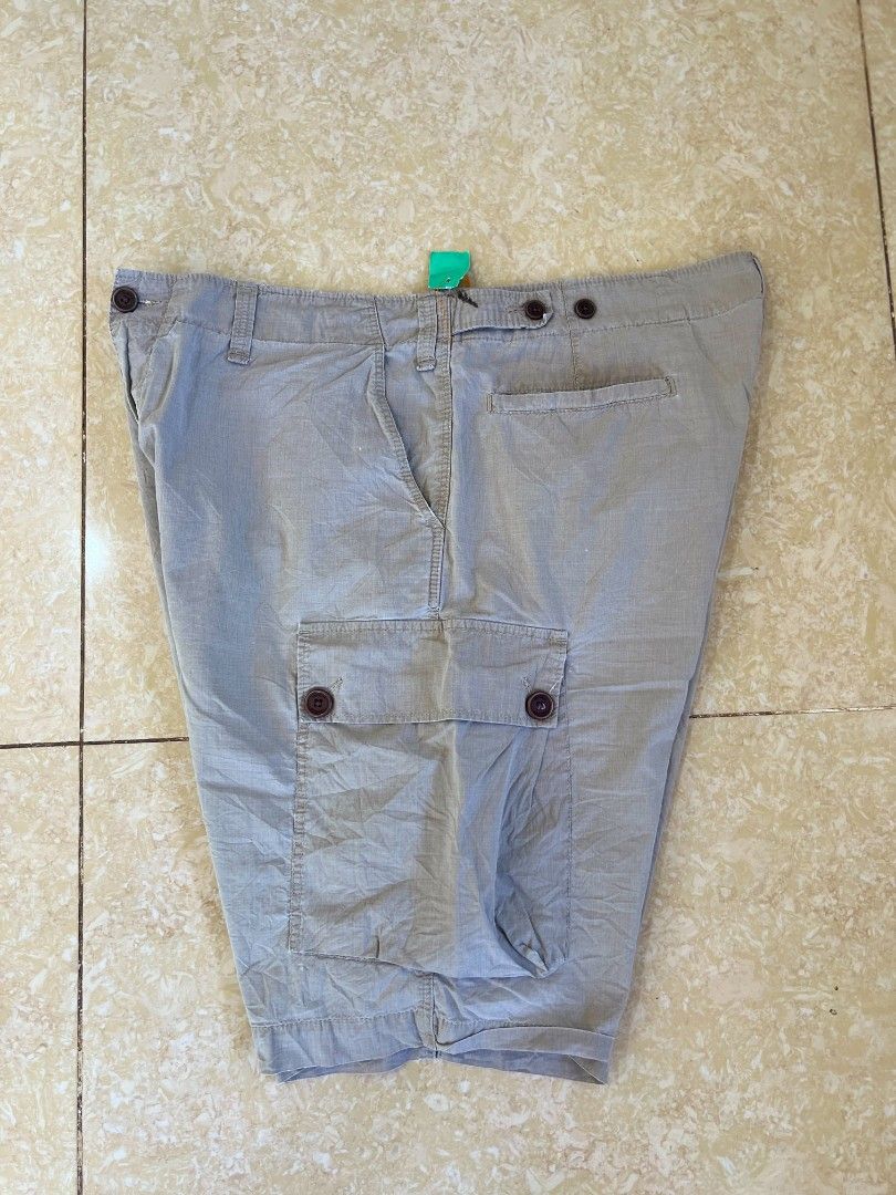Lacoste Cargo Shorts Grey (Category: Shorts) located in Bacoor. Submitted by davealvare39194 (Listing ID 1465858620, Image 1). Description: - Brand: Lacoste - Color: Versatile Grey - Style: Cargo shorts with multiple functional pockets and side pocket flaps - Closure: Secure button waist closure - Details: Classic crocodile logo patch on the back right pocket - Fit/Use: Comfortable fit, ideal for casual everyday wear or outdoor adventures - Pairi