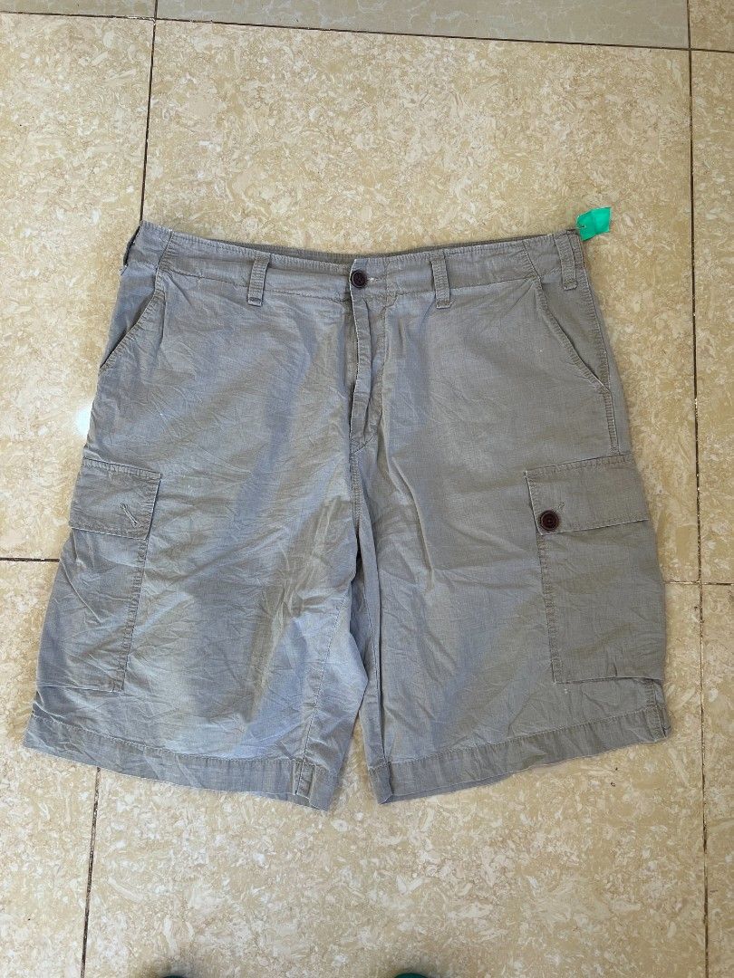 Lacoste Cargo Shorts Grey (Category: Shorts) located in Bacoor. Submitted by davealvare39194 (Listing ID 1465858620, Image 3). Description: - Brand: Lacoste - Color: Versatile Grey - Style: Cargo shorts with multiple functional pockets and side pocket flaps - Closure: Secure button waist closure - Details: Classic crocodile logo patch on the back right pocket - Fit/Use: Comfortable fit, ideal for casual everyday wear or outdoor adventures - Pairi
