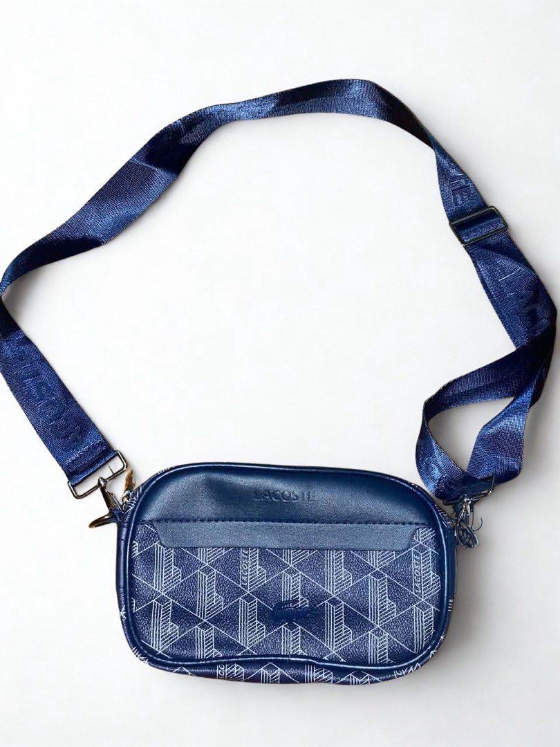Lacoste Navy Blue Monogram Crossbody Bag (Category: Cross-body Bags) located in Mandaluyong City. Submitted by bayline999 (Listing ID 1465778525, Image 1). Description: With dustbag and ziplock.