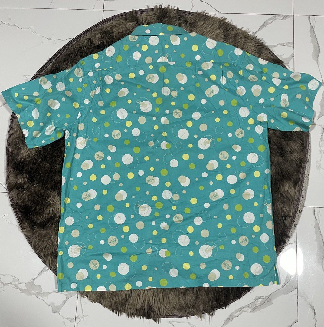 Lacoste Turquoise All Overprint Polo (Category: Formal Shirts) located in Calapan. Submitted by lucasthrifts (Listing ID 1465922343, Image 2). Description: - Brand: Lacoste - Size: Large( Approx. 23 inches pit-to-pit) - Color/Design: Turquoise with white & lime green polka dots and faint alligator graphics - Details: Short sleeve, button-up, pointed collar, single chest pocket with embroidered green crocodile logo - Material: Lightweight fabric w