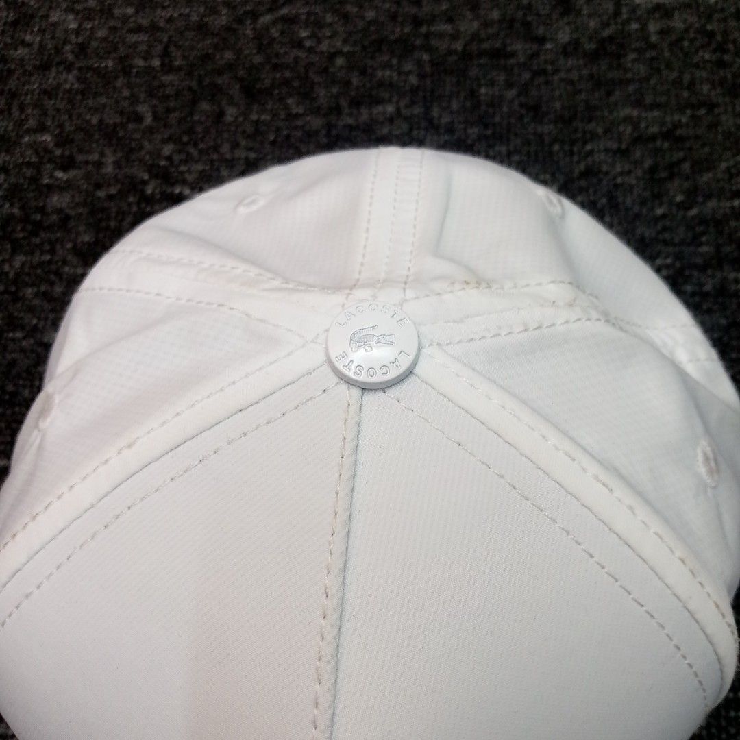 Lacoste White Baseball Cap with Graphic Crocodile Logo (Category: Caps & Hats) located in Manila. Submitted by pablopresk0. (Listing ID 1465835044, Image 2). Description: - Brand: Lacoste - Color: Clean white with blue and red graphic stripes - Logo: Outline crocodile with graphic background - Fit: Adjustable strap at the back with a secure metal clasp - Details: Branded Lacoste tape on interior seams and original round sticker on the brim - Cond