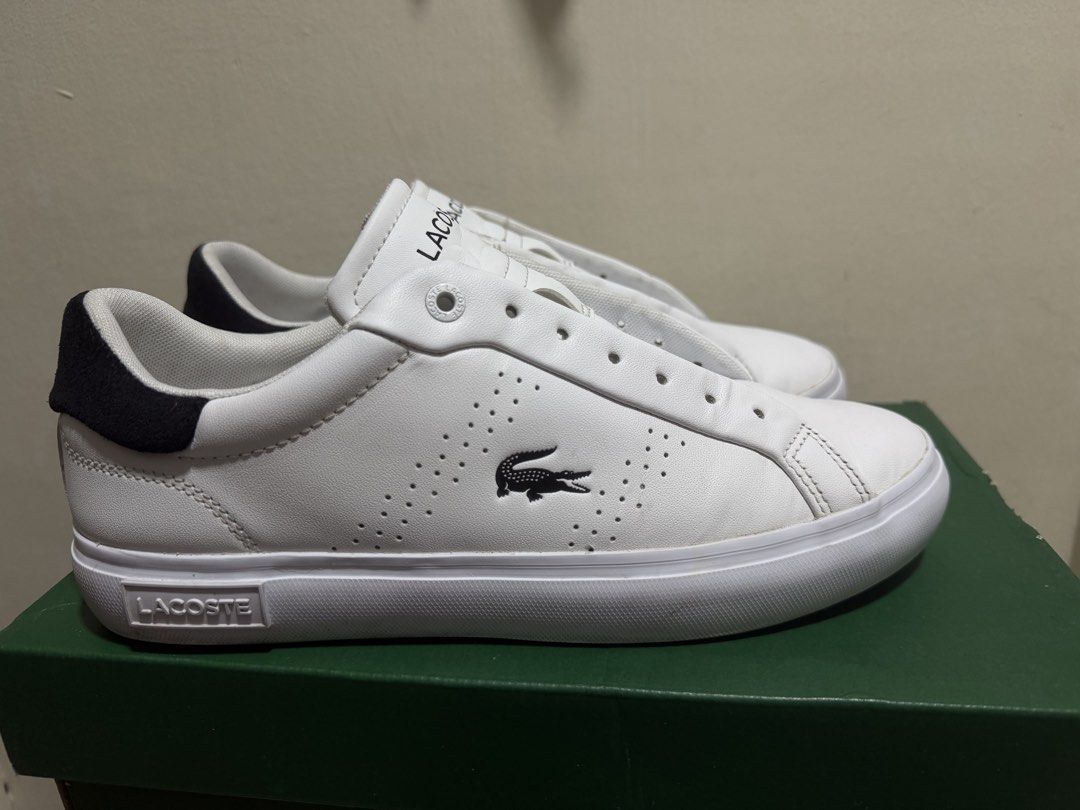 Lacoste White Sneakers with Black Heel (Category: Sneakers) located in Marikina City. Submitted by iamjhoms (Listing ID 1465809228, Image 1). Description: - Brand: Lacoste - Colorway: White with black heel panel - Features: Embroidered crocodile logo, perforated midfoot detailing, and embossed rubber sole - Condition note: Laces are missing from the eyelets - Inclusion: Original green box included - Perfect for smart-casual everyday wear.