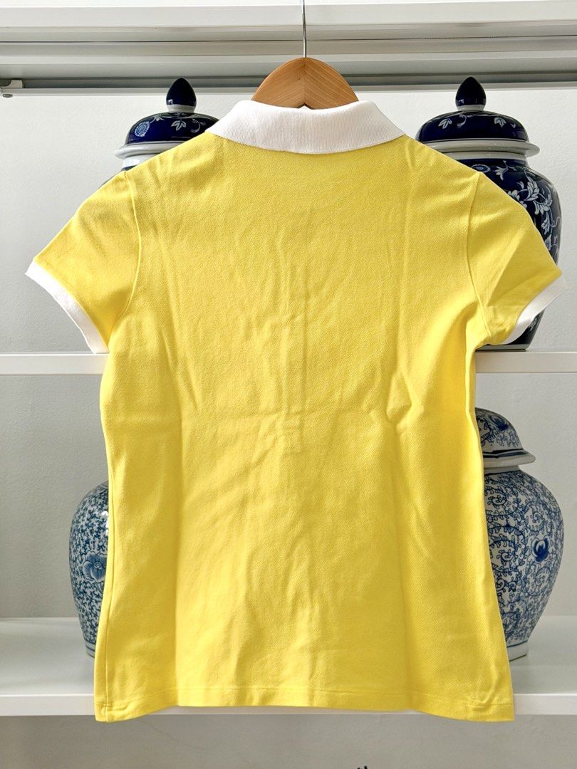 Lacoste Yellow Polo Shirt Size 36 (Category: Babies & Kids Fashion) located in Lipa City. Submitted by pauline0303 (Listing ID 1465765772, Image 3). Description: - Brand: Lacoste - Authentic - Color: Bright yellow with contrasting white collar and sleeve cuffs - Size: 36 (Made in Peru) - Details: Classic 5-button placket and embroidered green crocodile logo on chest - Condition: Clean fabric with solid stitching - Style: Great staple piece for ca