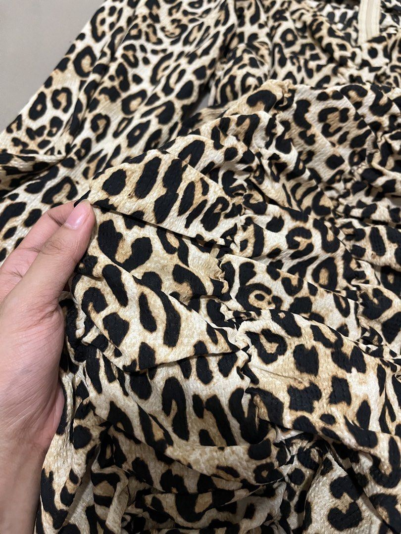 Leopard Long Sleeve Ruched Dress (Category: Dresses) located in Marikina City. Submitted by maicsg_ (Listing ID 1465773145, Image 2). Description: - Trendy leopard print mini dress - Flattering V-neckline and hidden back zipper - Heavy ruching details through the front and skirt - Soft, slightly stretchy fabric with elastic sleeve cuffs - Perfect statement piece for parties and nights out - Fits true to size.