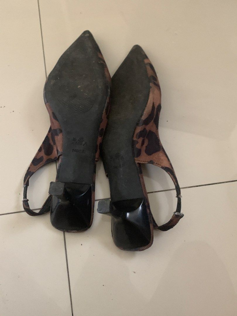 Leopard print pointed toe slingback kitten heels (Category: Heels) located in Manila. Submitted by pureforest_68db5f (Listing ID 1465820395, Image 3). Description: - Style: Leopard print slingback heels with pointed toe and low kitten heel - Size: 240 / EUR 38 - Color: Leopard print upper with black insoles, heel, and elastic strap - Condition: Pre-loved, worn a few times with light wear on the bottom soles and slight fraying on the elastic strap