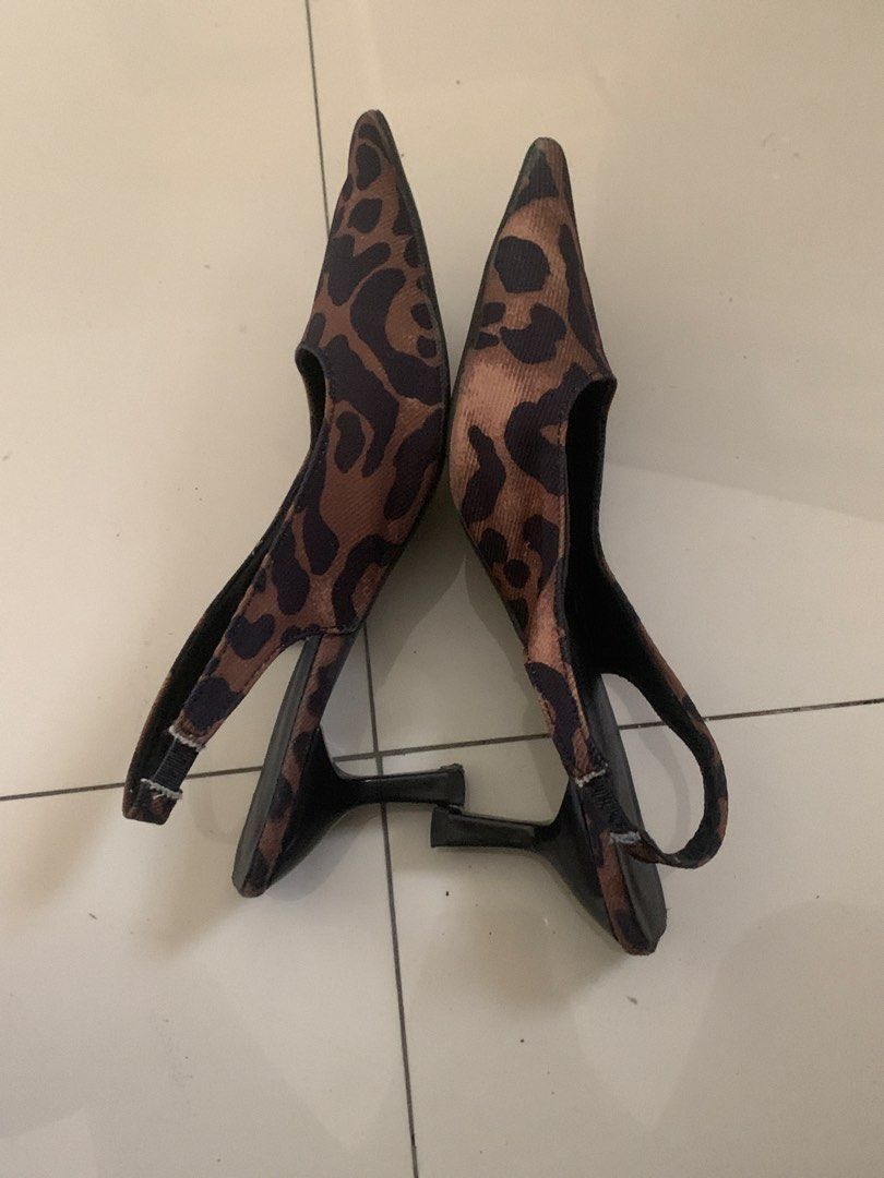 Leopard print pointed toe slingback kitten heels (Category: Heels) located in Manila. Submitted by pureforest_68db5f (Listing ID 1465820395, Image 2). Description: - Style: Leopard print slingback heels with pointed toe and low kitten heel - Size: 240 / EUR 38 - Color: Leopard print upper with black insoles, heel, and elastic strap - Condition: Pre-loved, worn a few times with light wear on the bottom soles and slight fraying on the elastic strap