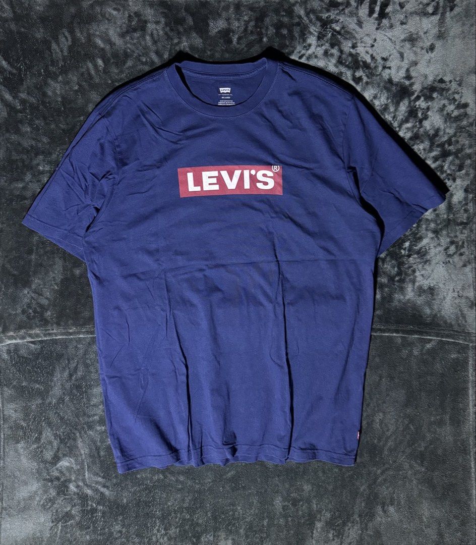 Levi's Blue Box Logo T-Shirt (Category: Tshirts & Polo Shirts ) located in Manila. Submitted by giormagne (Listing ID 1465833454, Image 1). Description: - Brand: Levi's - Color: Dark blue with classic red box logo on chest - Fit: Relaxed fit, short sleeves - Material: Soft and comfortable cotton - Origin: Made in Pakistan - Condition: Excellent, clean neck tag with sizing details - PM for fast transactions and shipping options!.