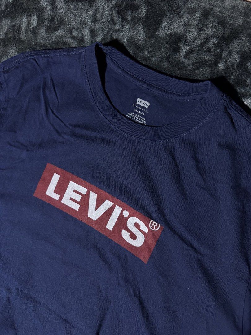 Levi's Blue Box Logo T-Shirt (Category: Tshirts & Polo Shirts ) located in Manila. Submitted by giormagne (Listing ID 1465833454, Image 2). Description: - Brand: Levi's - Color: Dark blue with classic red box logo on chest - Fit: Relaxed fit, short sleeves - Material: Soft and comfortable cotton - Origin: Made in Pakistan - Condition: Excellent, clean neck tag with sizing details - PM for fast transactions and shipping options!.