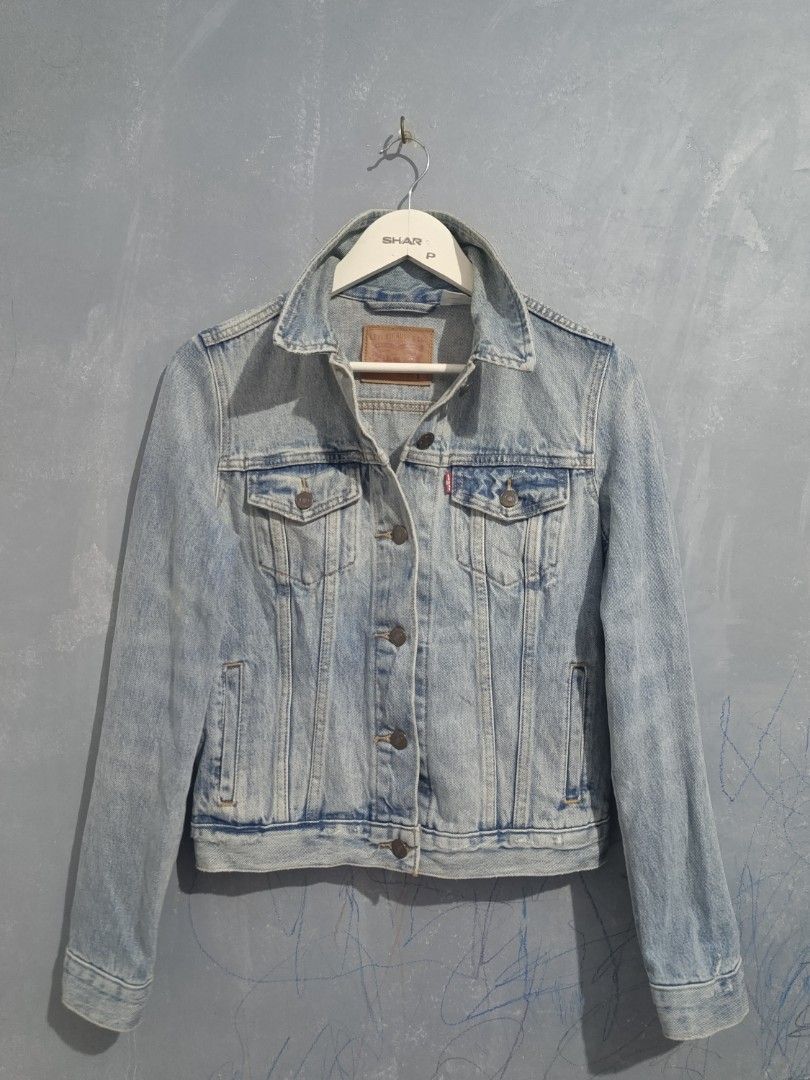Levi's Classic Light Wash Denim Jacket Size S (Category: Coats, Jackets and Outerwear) located in Iloilo. Submitted by wendxcz-thrift- (Listing ID 1465930957, Image 1). Description: Levi's denim jacket in light blue wash. Classic button-up front with chest flap pockets and side welt pockets. Leather branded patch at the back collar and red tab on the pocket. Size small. Great everyday outer layer. MOP: GCASH/BPI + SF.