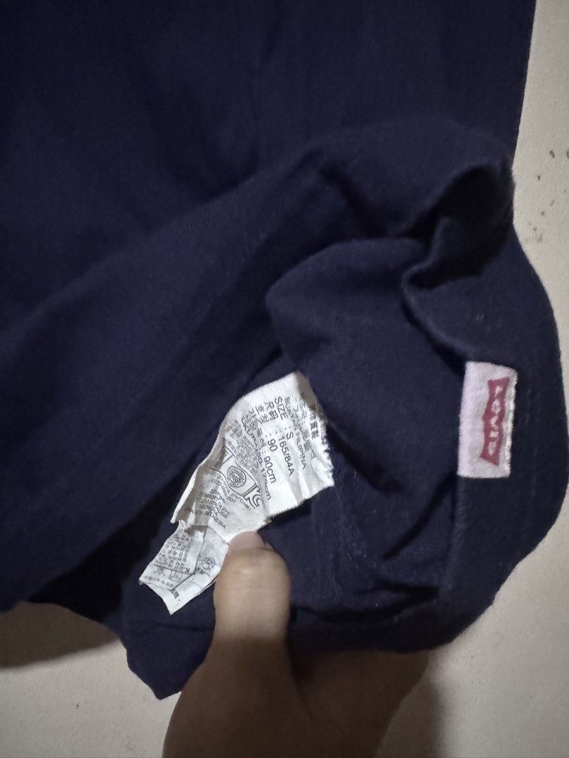 Levis Tshirt (Category: Tshirts & Polo Shirts ) located in Danao, Cebu. Submitted by welvirinec29053 (Listing ID 1465779580, Image 3). Description: This navy blue t-shirt features a faded "S.F. 1853" graphic print across the chest and a small red Levi's tag at the bottom hem. size S fit to medium dimes 19x27 color rate 9.5/10.