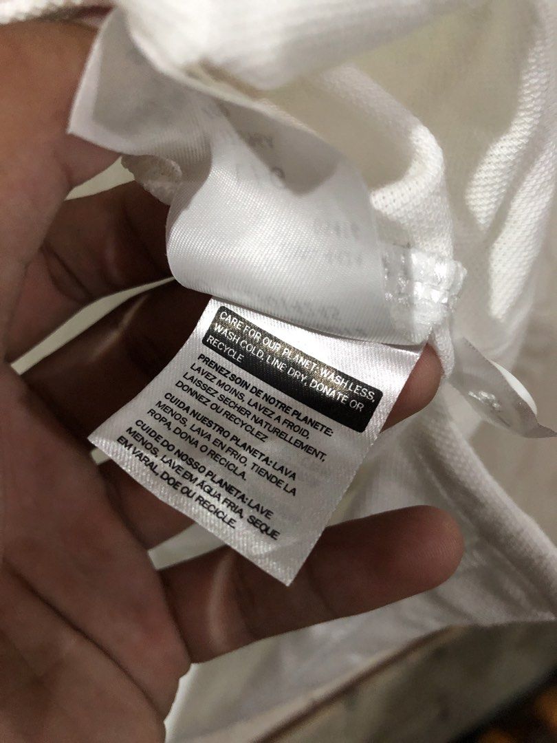Levi's White Polo Shirt Size L (Category: Tshirts & Polo Shirts ) located in Magsaysay. Submitted by ryns_thrifting (Listing ID 1465896156, Image 3). Description: - Brand: Levi's - Color: White - Size: Large - Material: Breathable cotton pique fabric - Design: Classic three-button placket with ribbed collar and arm cuffs - Details: Embroidered red batwing logo on chest and signature red tab on lower side seam - Condition/Style: Clean look, perfec