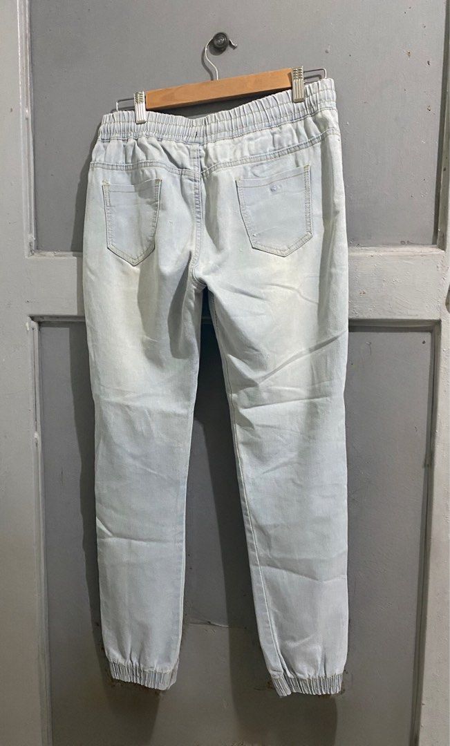 Light-Washed Ripped Denim Jogger Pants (Category: Jeans) located in Manila. Submitted by mturla4011142 (Listing ID 1465884001, Image 2). Description: Details : Front: Elastic garter waist with drawstring, 2 pockets, jogger cut (garterized at ankle) Back: 2 patch pockets Design: Heavily distressed / ripped on both front legs — that’s the style, not sira. Intentional punit Color: Light blue / acid wash denim, looks like soft stretchy denim, not har