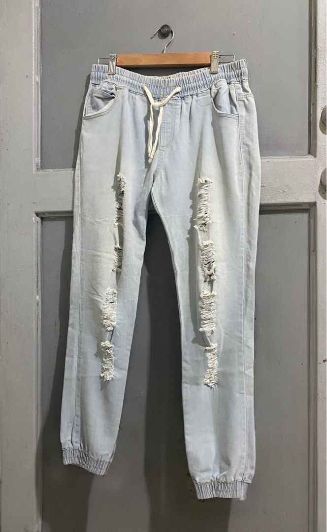 Light-Washed Ripped Denim Jogger Pants (Category: Jeans) located in Manila. Submitted by mturla4011142 (Listing ID 1465884001, Image 1). Description: Details : Front: Elastic garter waist with drawstring, 2 pockets, jogger cut (garterized at ankle) Back: 2 patch pockets Design: Heavily distressed / ripped on both front legs — that’s the style, not sira. Intentional punit Color: Light blue / acid wash denim, looks like soft stretchy denim, not har
