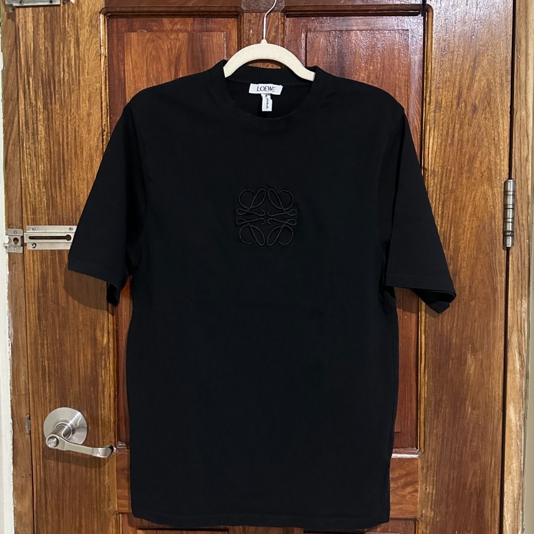 Loewe Embroidered Anagram T-Shirt (Category: Tshirts & Polo Shirts ) located in Lucena. Submitted by the.hidden.closet (Listing ID 1465935702, Image 2). Description: DECLUTTERING SALE ✨ Black-on-black embroidered logo Minimalist & easy to style Still in good condition Perfect for everyday wear Size: 18.5" Width | 28" Length.