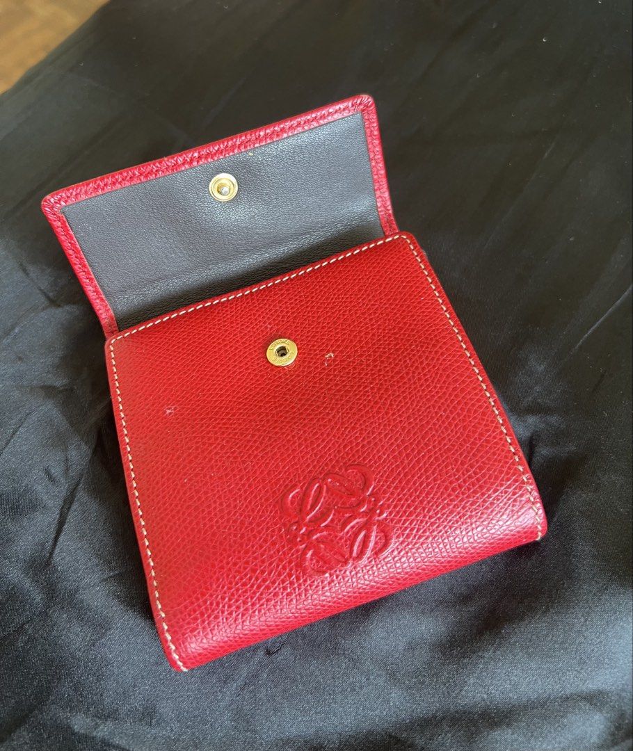 Loewe Puzzle Leather Wallet (Red) (Category: Wallets & Card holders) located in Mandaluyong City. Submitted by chelseayb47224 (Listing ID 1465818446, Image 3). Description: Red pebbled leather exterior with debossed Anagram logo on the front. Dark grey interior lining with multiple card slots. Secure snap-button closure on the back coin pocket and tab closure for the main compartment. Shows minor signs of wear on the leather and hardware..