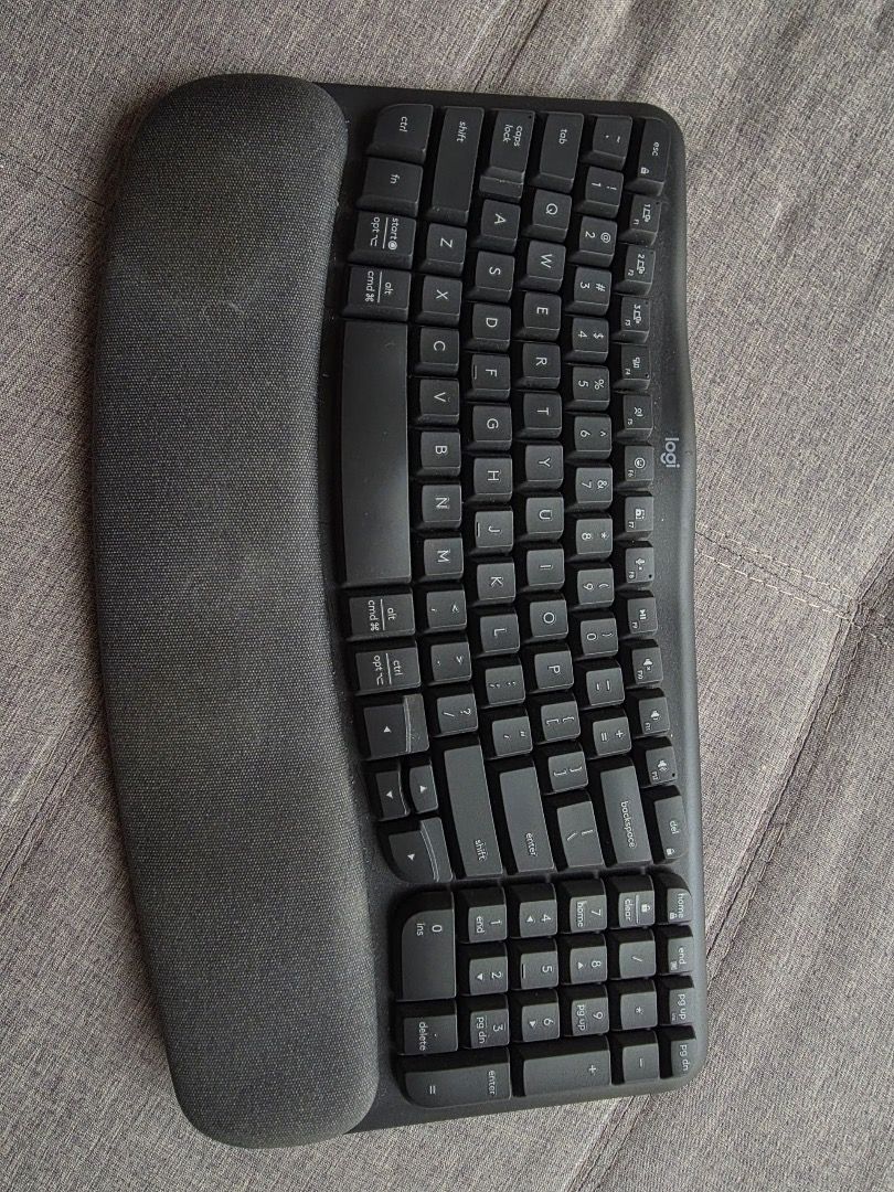 Logitech Wave Keys (Category: Computer Keyboard) located in Petaling Jaya. Submitted by wnger (Listing ID 1465865639, Image 1). Description: - Brand: Logitech - Type: Wave Keys - Color: Dark grey - Comfort: Built-in cushioned wrist rest and curved keyframe for natural hand posture - Condition: Clean overall shape with minor dust on the wrist pad - Ideal for: All-day typing comfort and long desk work sessions - Keyboard only, no box. Negotiable .