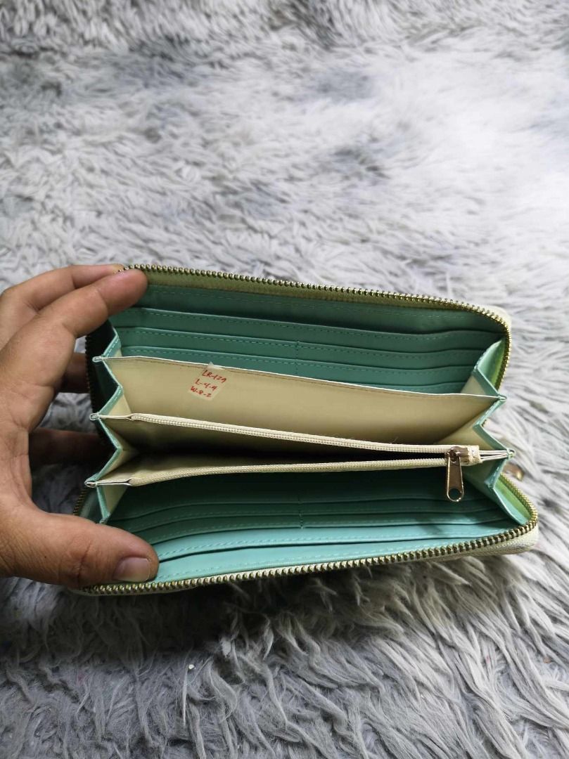 Long Zip Around Wallet With Dual Decorative Buckle Strap (Category: Wallets & Card holders) located in Santa Cruz. Submitted by jmy_surplus.2 (Listing ID 1465880899, Image 3). Description: Size ; L- 4.4 W - 8.2 Color ; Cream Type ; Wallet Brand ; No brand Material ; Leather Style ; Zipper Closure Long Wallet With Coin Compartment LR 129 JMY 5 Batch #224.