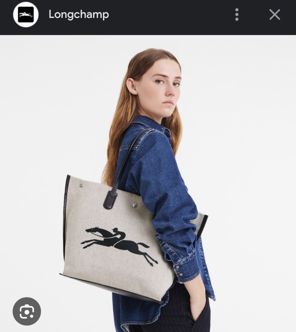 🐴Longchamp Extra Large Ecru Canvas Tote Bag (Category: Luxury Bags & Wallets) located in Manila. Submitted by PrinceDani.Clothing (Listing ID 1465830335, Image 2). Description: - Authentic Longchamp tote bag made in France - Natural canvas body with sleek black leather handles and trim - Large logo on the front and iconic running horse logo on the back - Roomy everyday carryall, fits a laptop and daily essentials easily.