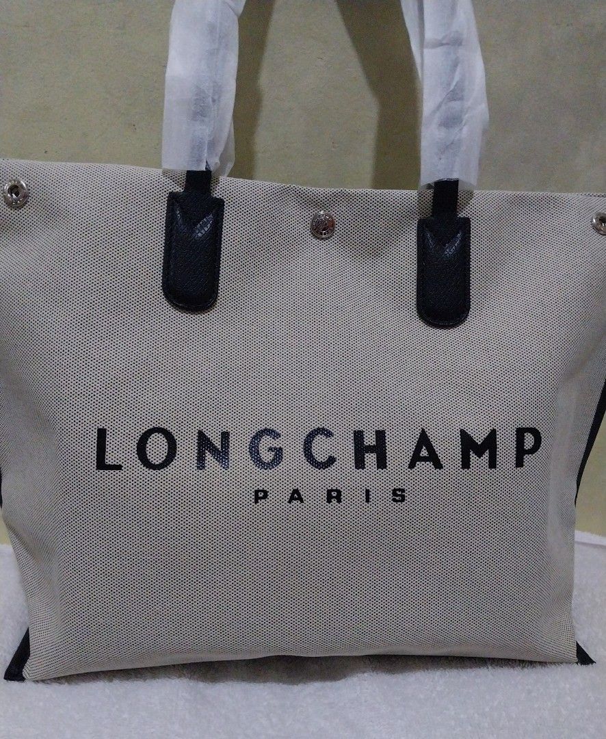 🐴Longchamp Extra Large Ecru Canvas Tote Bag (Category: Luxury Bags & Wallets) located in Manila. Submitted by PrinceDani.Clothing (Listing ID 1465830335, Image 3). Description: - Authentic Longchamp tote bag made in France - Natural canvas body with sleek black leather handles and trim - Large logo on the front and iconic running horse logo on the back - Roomy everyday carryall, fits a laptop and daily essentials easily.