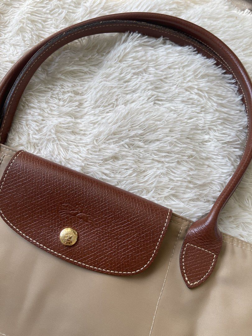 Longchamp Le Pliage Beige Tote Bag (Category: Luxury Bags & Wallets) located in Malolos. Submitted by ishnnt (Listing ID 1465905171, Image 2). Description: - Authentic Longchamp Le Pliage tote bag in classic beige - Durable nylon body with iconic brown leather handles and flap - Elegant gold-tone hardware with signature horse rider logo - Spacious interior, easily fits a laptop and daily essentials - Lightweight, foldable, and perfect for everyda