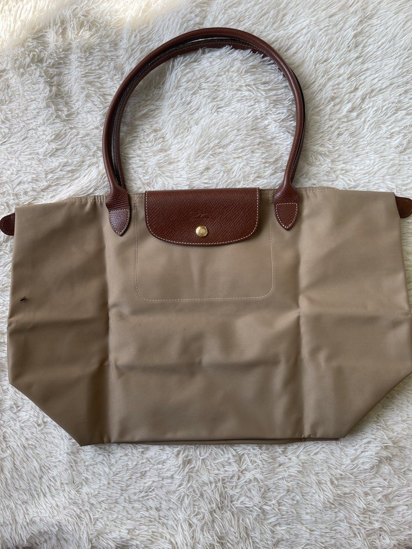 Longchamp Le Pliage Beige Tote Bag (Category: Luxury Bags & Wallets) located in Malolos. Submitted by ishnnt (Listing ID 1465905171, Image 1). Description: - Authentic Longchamp Le Pliage tote bag in classic beige - Durable nylon body with iconic brown leather handles and flap - Elegant gold-tone hardware with signature horse rider logo - Spacious interior, easily fits a laptop and daily essentials - Lightweight, foldable, and perfect for everyda