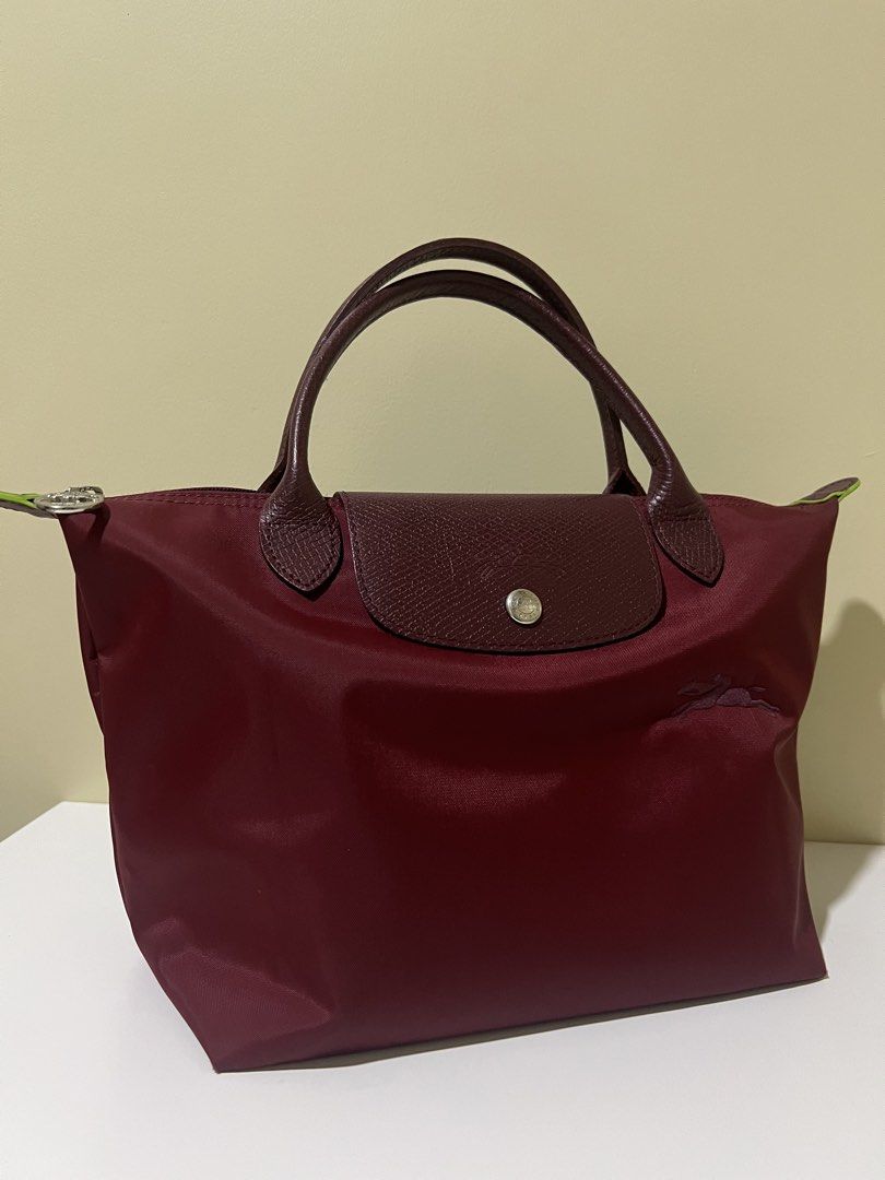 Longchamp Le Pliage handbag burgundy (Category: Luxury Bags & Wallets) located in Manila. Submitted by theprelovedbasics (Listing ID 1465882126, Image 1). Description: Selling my preloved Longchamp Le Pliage small tote. RFS: To buy a bigger one. Free bag organizer DM me for more details!.