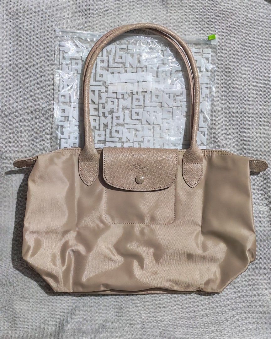 Longchamp Le Pliage One Beige (Category: Luxury Bags & Wallets) located in Quezon City. Submitted by sureandlegit (Listing ID 1465868265, Image 2). Description: For Sale Longchamp Le Pliage One Medium Size Long Handle Beige color, latest from longchamp Monochromatic color from handle and button With two pockets inside Bought from Taiwan Airport last June. Used only for a week Good as new condition What you see what you get. Available on hand Pls 