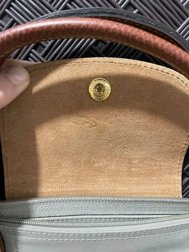 Longchamp Le Pliage Short Handle Tote Bag Grey (Category: Luxury Bags & Wallets) located in Pagadian. Submitted by teacher_rowelyn (Listing ID 1465762940, Image 3). Description: Grey nylon body with brown leather handle and flap snap closure. Gold tone hardware. Foldable design with top zipper. Classic everyday tote bag with short handles. Clean interior lining with slip pocket. Lightweight and practical daily carryall..