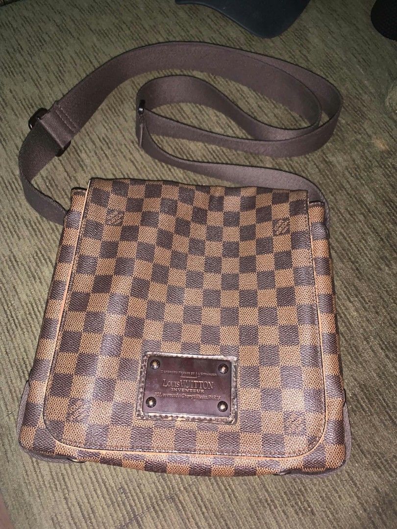Louis Vuitton Damier Ebene Messenger Bag (Category: Luxury Bags & Wallets) located in San Juan City. Submitted by findmorelux (Listing ID 1465859073, Image 1). Description: - Louis Vuitton messenger bag in iconic brown Damier Ebene canvas - Adjustable brown fabric shoulder strap with sturdy metal hardware hooks - Front flap closure accented with a signature Louis Vuitton engraved metal plaque - Spacious fabric-lined interior with an original leat