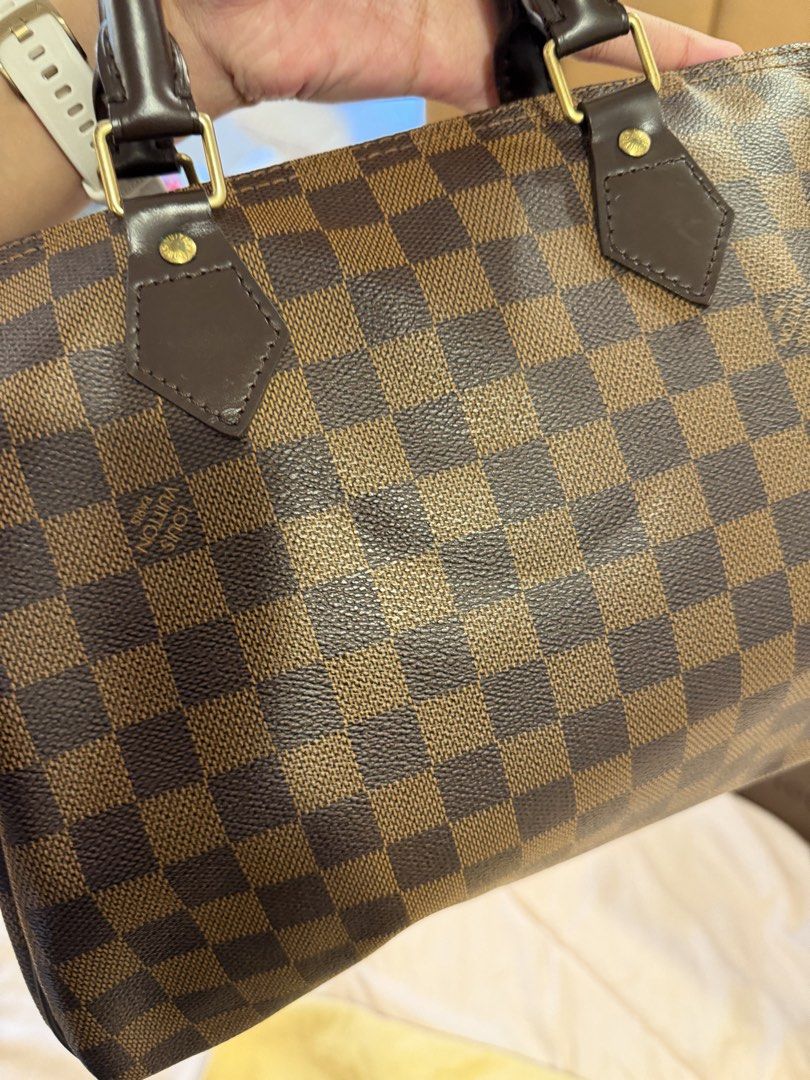 Louis Vuitton Damier Ebene Speedy Handbag (Category: Luxury Bags & Wallets) located in Las Pinas. Submitted by privari (Listing ID 1465795285, Image 3). Description: - Brand/Model: Louis Vuitton Handbag - Material: Damier Ebene canvas with dark brown leather handles - Hardware: Gold-tone hardware - Closure: Classic zip top closure - Interior: Vibrant red textile lining - Inclusions: Original box, dust bag, padlock, and keys - Condition: Excellent