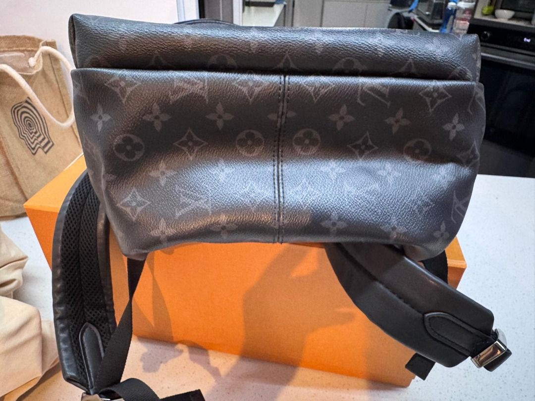 Louis Vuitton Monogram Eclipse Christopher Backpack (Category: Backpacks) located in Singapore. Submitted by noraborhan (Listing ID 1465830686, Image 2). Description: - Model: Monogram Eclipse Canvas Backpack - Color: Dark Grey / Black - Features: Large main compartment & front zip pocket - Comfort: Adjustable padded shoulder straps with silver-tone hardware - Design: Structured base & sturdy top handle - Condition: Clean canvas exterior with min