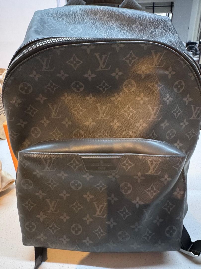 Louis Vuitton Monogram Eclipse Christopher Backpack (Category: Backpacks) located in Singapore. Submitted by noraborhan (Listing ID 1465830686, Image 1). Description: - Model: Monogram Eclipse Canvas Backpack - Color: Dark Grey / Black - Features: Large main compartment & front zip pocket - Comfort: Adjustable padded shoulder straps with silver-tone hardware - Design: Structured base & sturdy top handle - Condition: Clean canvas exterior with min