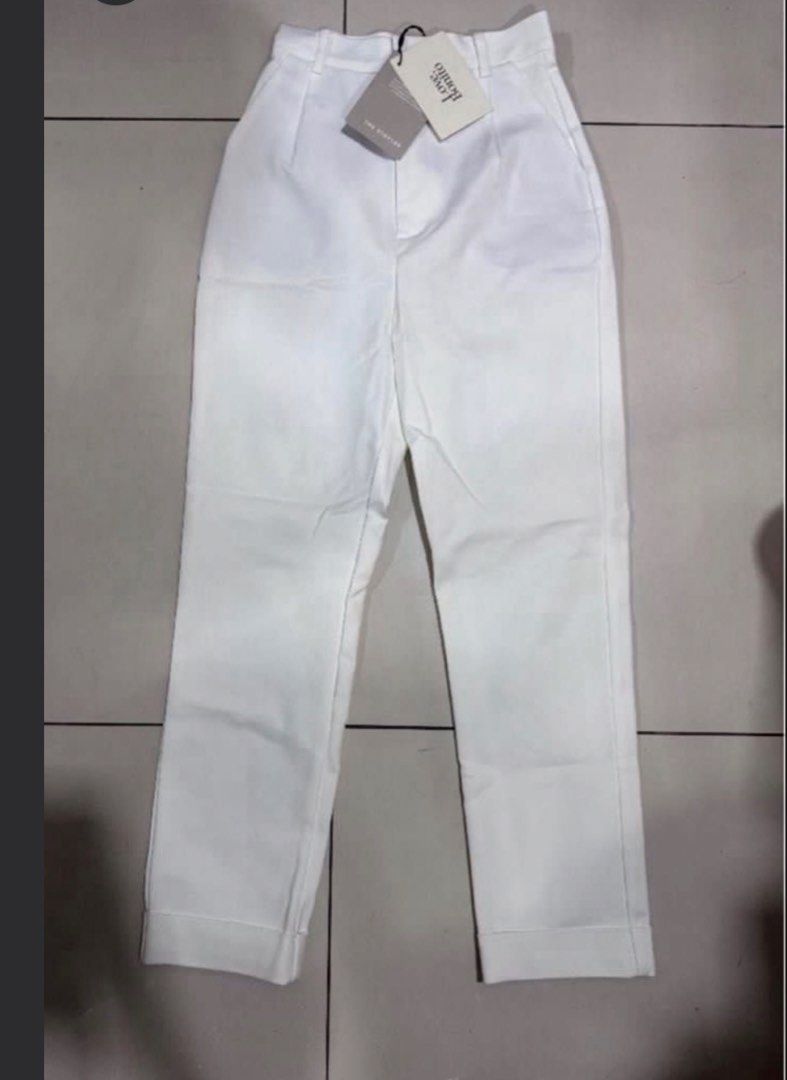 Love Bonito White Tapered Pants (Category: Jeans) located in Manila. Submitted by decluterthings888 (Listing ID 1465879473, Image 2). Description: - Brand new with original tags attached - Crisp white shade, perfect for work or smart casual wear - High-waisted fit with stylish front pleats - Features trendy rolled-up cuffs and functional side pockets - A versatile staple piece from the Love Bonito collection.