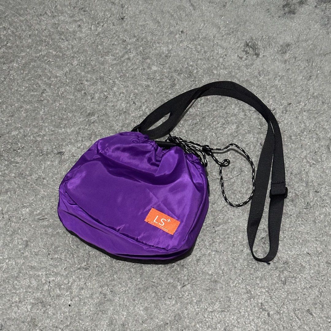 LS+ Purple Nylon Drawstring Crossbody Bag (Category: Cross-body Bags) located in Lipa City. Submitted by jecoparra (Listing ID 1465919196, Image 2). Description: - Color: Bright purple with black adjustable strap - Material: Lightweight nylon - Closure: Drawstring top with patterned cinch cords - Details: Front pocket with orange rectangular LS+ logo - Capacity: Roomy enough for phone, keys, and small wallet - Style: Perfect for daily use and cas