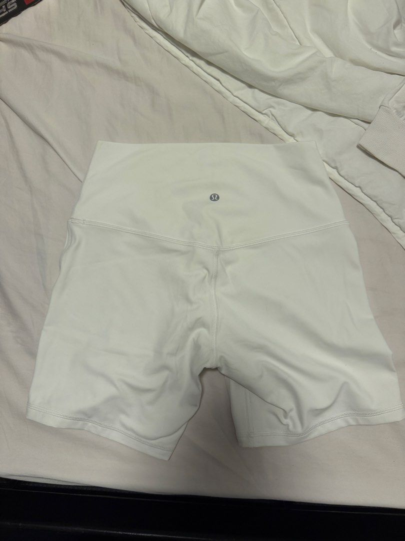 Lululemon White High-Rise Shorts Size 8 (Category: Shorts) located in Manila. Submitted by gongonpo (Listing ID 1465806165, Image 2). Description: - Brand: Lululemon - Item: Athletic Shorts - Size: 8 (Tag attached) - Color: White - Fit: High-rise - Material: Nylon and Lycra elastane blend - Details: Silver logo on back waistband - Condition: Brand new with tag - Best for: Workouts, yoga, or everyday casual wear - Size 8 - Not used.