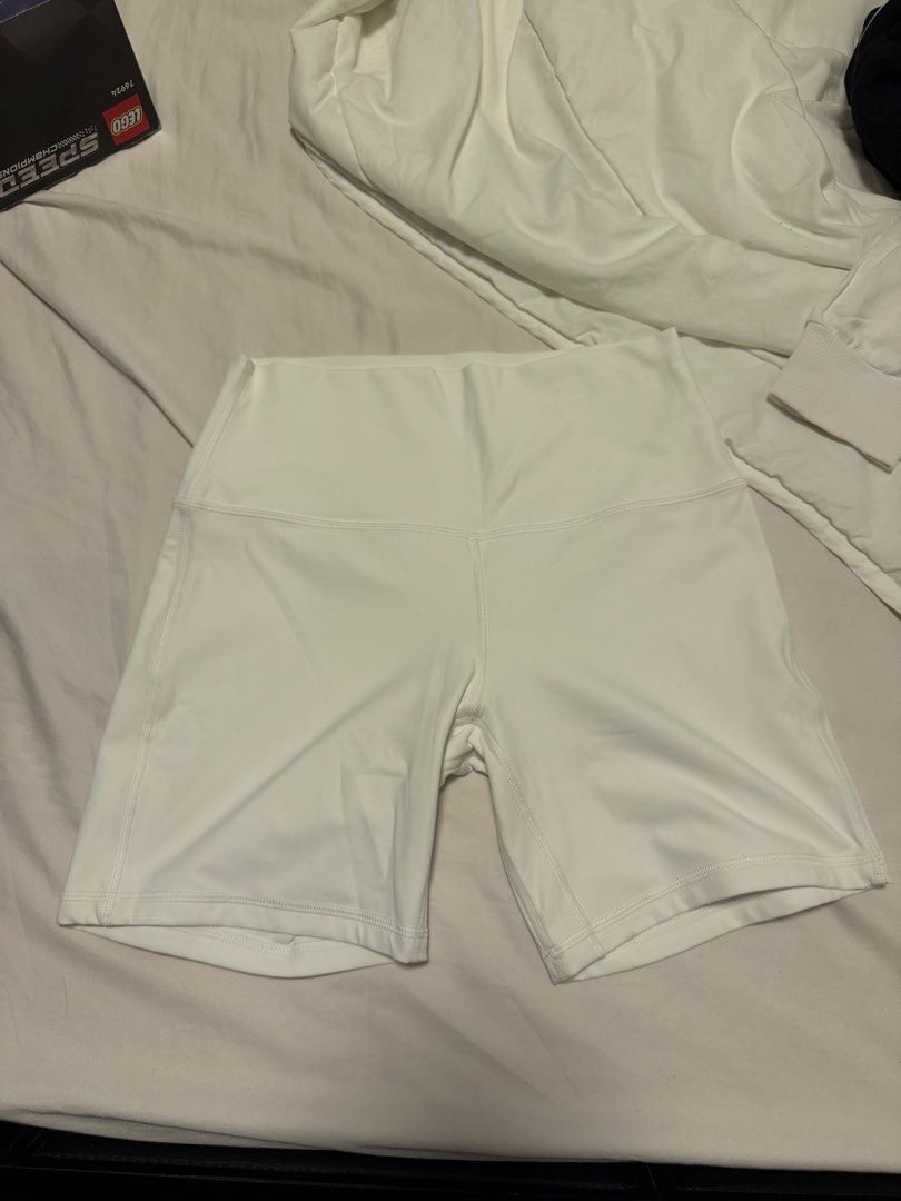 Lululemon White High-Rise Shorts Size 8 (Category: Shorts) located in Manila. Submitted by gongonpo (Listing ID 1465806165, Image 3). Description: - Brand: Lululemon - Item: Athletic Shorts - Size: 8 (Tag attached) - Color: White - Fit: High-rise - Material: Nylon and Lycra elastane blend - Details: Silver logo on back waistband - Condition: Brand new with tag - Best for: Workouts, yoga, or everyday casual wear - Size 8 - Not used.