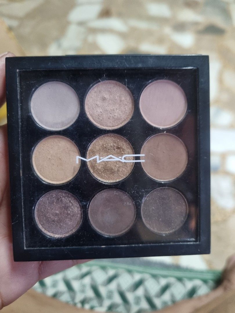 MAC Amber Times Nine Eyeshadow Palette (Category: Makeup) located in Manila. Submitted by monya111 (Listing ID 1465761319, Image 1). Description: - Brand: MAC Cosmetics - Shade Selection: 9 neutral shades in brown, taupe, and bronze tones - Finishes: Mix of versatile matte and shimmer finishes - Packaging: Standard square black compact with a clear lid - Condition: Gently used (light surface wear on some pans from swatches/brushes) - Highlights: 