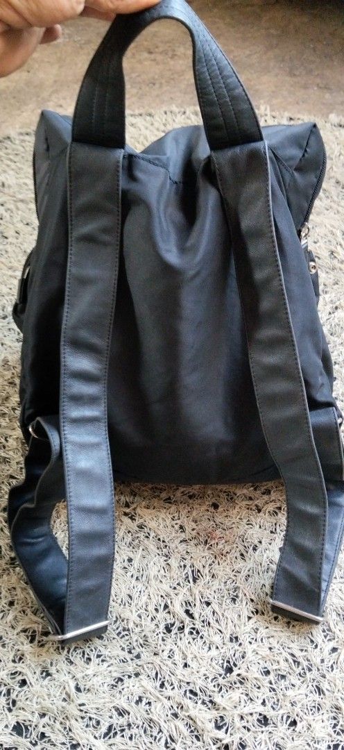 Mandarina Duck Black Nylon Backpack (Category: Backpacks) located in Paranaque City. Submitted by michael-08 (Listing ID 1465898351, Image 2). Description: - Brand: Mandarina Duck - Color: Classic Black - Material: Durable, high-quality nylon - Condition: Clean inside and out - Pockets: Front zipped pocket and roomy main compartment - Closures: Secure top and side zipper closures - Carry Options: Double shoulder straps and top grab handle - Hardw