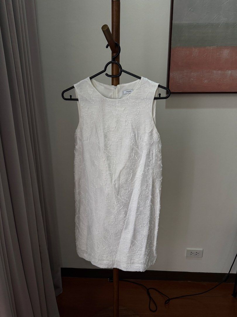 Mango White Sleeveless Dress Size S (Category: Dresses) located in Pasig City. Submitted by kutleyn (Listing ID 1465760110, Image 1). Description: - Brand: Mango - Style: Sleeveless mini dress - Color: White with textured patterned fabric - Details: Round neckline, back zipper closure, fully lined - Size: EUR S, USA 4, MEX CH - Condition: Clean, excellent, and ready to wear.