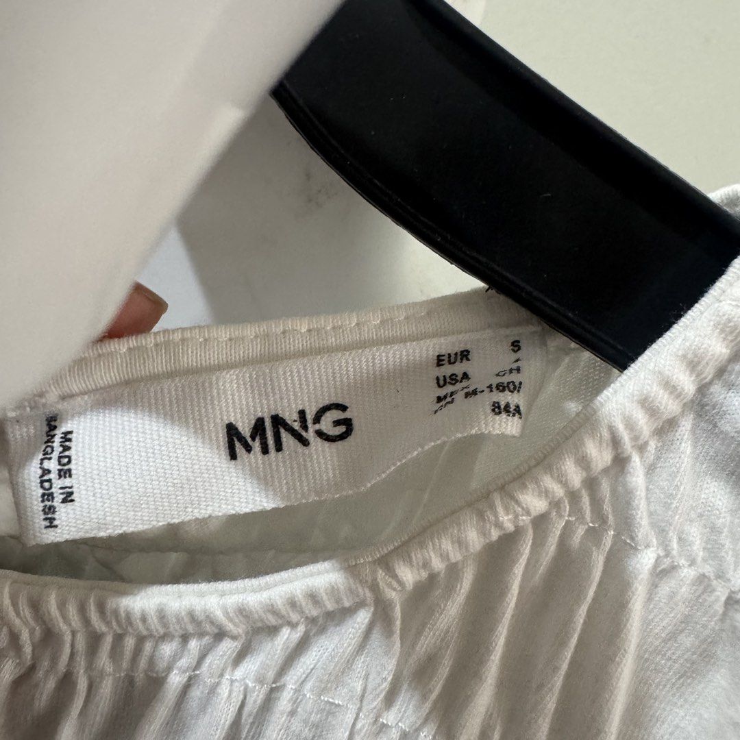 Mango White Smocked Midi Dress Size S (Category: Dresses) located in Marikina City. Submitted by preloved_n_reloved (Listing ID 1465828574, Image 2). Description: - Brand: Mango - Color: White - Size: EUR S / USA S - Design: Sleeveless with a fully smocked bodice and relaxed flare skirt - Origin: Made in Bangladesh - Material: Lightweight fabric, ideal for warm weather - Condition: Clean and well-maintained.