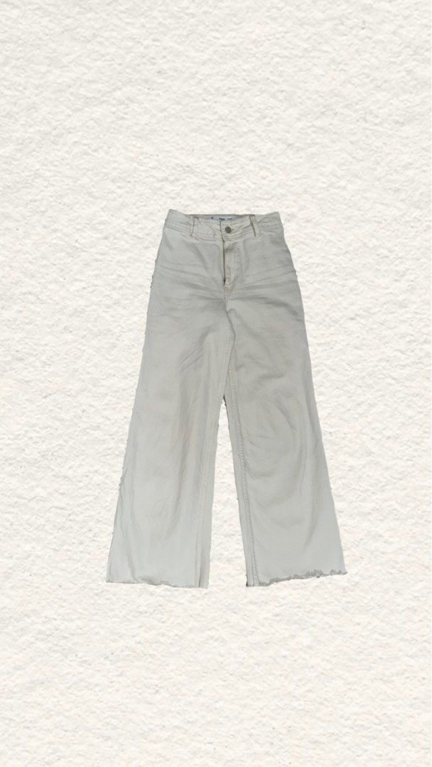 Mango White Wide Leg Jeans (Category: Jeans) located in Quezon City. Submitted by zealhorse_a9f3c3 (Listing ID 1465790941, Image 1). Description: - Brand: Mango - Color: Off-white - Style: High-waist wide leg with raw frayed hem - Features: Belt loops, front button closure, soft and comfortable denim - Versatility: Perfect basic piece for casual fits, easy to pair with sneakers or boots.
