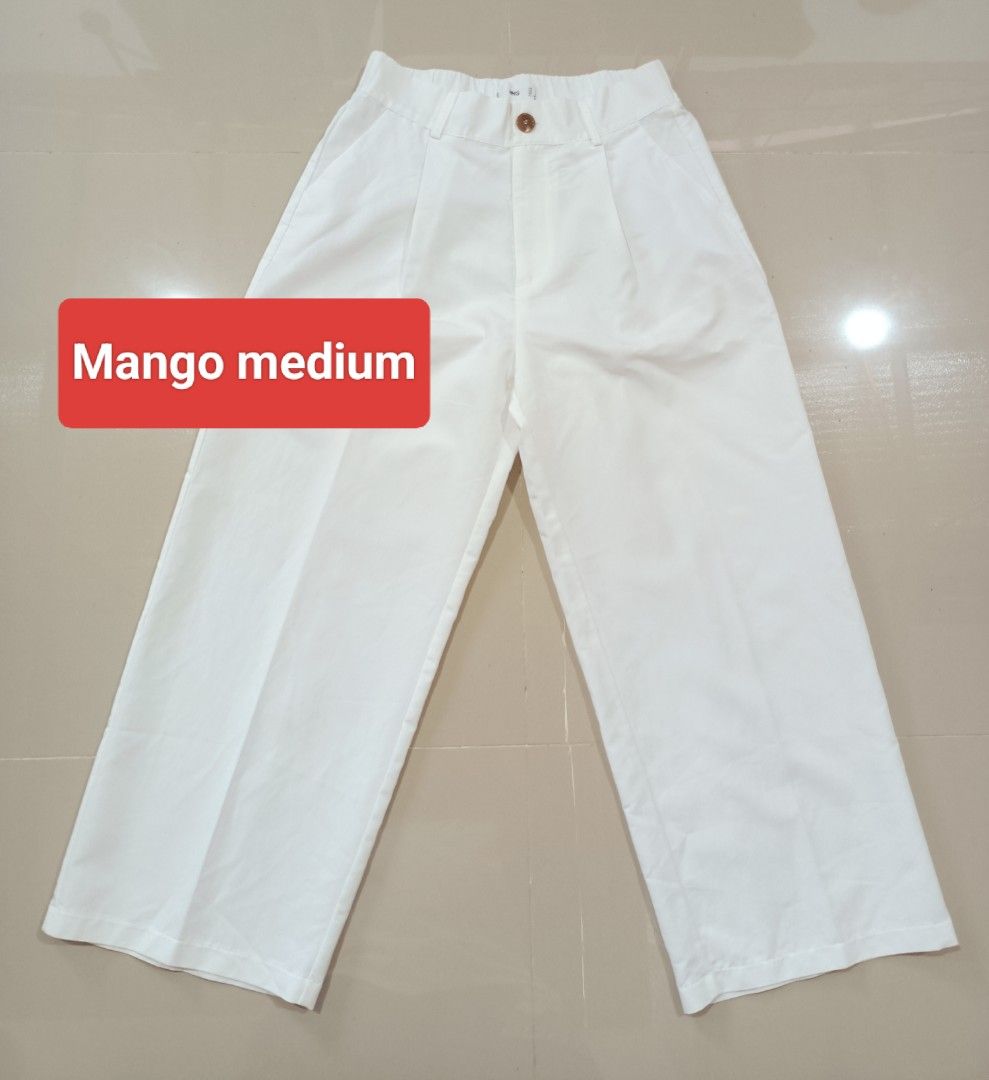 Mango White Wide Leg Pants Medium (Category: Jeans) located in Angeles City. Submitted by leichen57360 (Listing ID 1465887007, Image 1). Description: - Brand: Mango - Size: Medium - Color: White - Style: Wide leg, clean minimalist design - Details: Pleated front with single button closure - Versatility: Perfect for casual days and office wear.