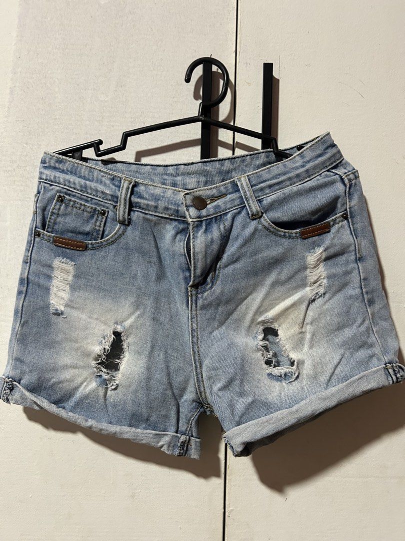 Maong/denim shorts (Category: Shorts) located in Manila. Submitted by maeshop2026 (Listing ID 1465842570, Image 1). Description: Size: 27 Maong skirt - Style: High-waist denim shorts with button closure - Wash: Light wash with trendy distressed rips and frayed details - Design: Rolled cuffs at the hem and stylish brown leather patch accents - Fit: Comfortable and flattering for warm weather - Pairing: Looks great with basic tees, crop tops, or ca