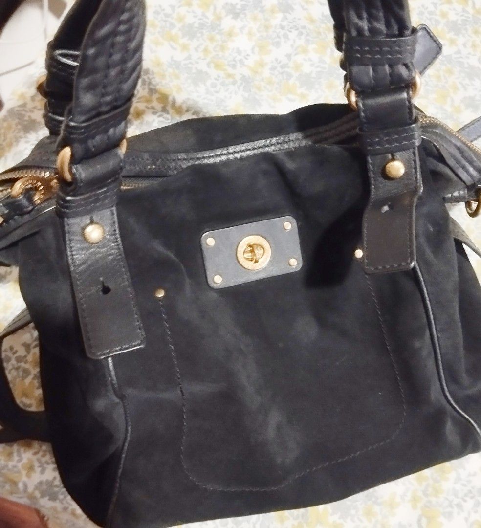 Marc by Marc Jacobs black suede handbag (Category: Cross-body Bags) located in Manila. Submitted by lene48 (Listing ID 1465760973, Image 2). Description: - Brand: Marc by Marc Jacobs - Material: Luxurious black suede with smooth leather trim - Hardware: Elegant gold-tone details - Closure: Secure zip top closure - Pockets: Convenient front pocket with gold turn-lock closure, plus interior and exterior pockets - Straps: Dual leather top handles an