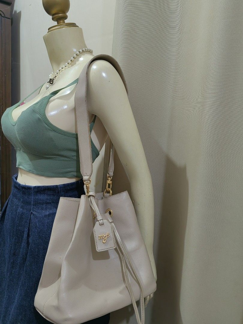 Marhen.J Beige Bucket Bag with Drawstring and Charm (Category: Shoulder Bags) located in Makati City. Submitted by prelovedtreatedwithlove (Listing ID 1465830547, Image 1). Description: - Brand: Marhen.J - Color: Versatile neutral beige - Material: Textured faux leather with elegant gold hardware - Closure: Secure top drawstring - Interior: Open compartment with a convenient side pocket - Includes: Matching brand charm on the strap - Condition: M
