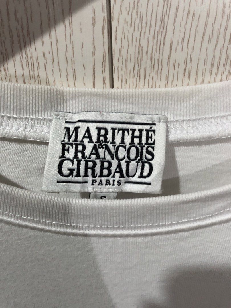 Marithe Francois Girbaud White Crop T-Shirt (Category: Shirts) located in Magsaysay. Submitted by ryns_thrifting (Listing ID 1465894533, Image 2). Description: - Brand: Marithé François Girbaud - Item: White cropped t-shirt with bold black chest logo - Size: S (Tag fit: Height 160-170cm, Chest 86-90cm) - Material: 100% breathable cotton - Condition: Clean, fresh white colorway - Styling: Perfect to pair with high-waisted jeans, shorts, or skirts 